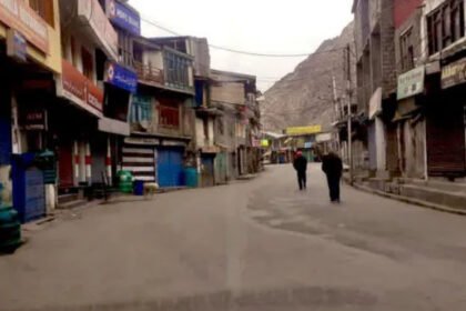 A wide shot of Kargil town showing empty streets and closed shops.