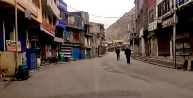 A wide shot of Kargil town showing empty streets and closed shops.