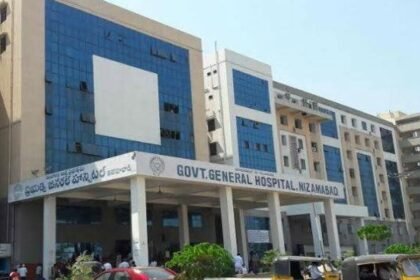 Exterior of the Nizamabad Government General Hospital in the early morning with police presence.