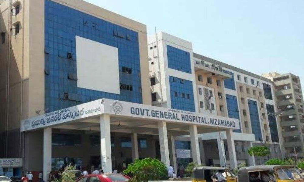 Exterior of the Nizamabad Government General Hospital in the early morning with police presence.