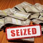 Police officers displaying seized fake ₹500 notes